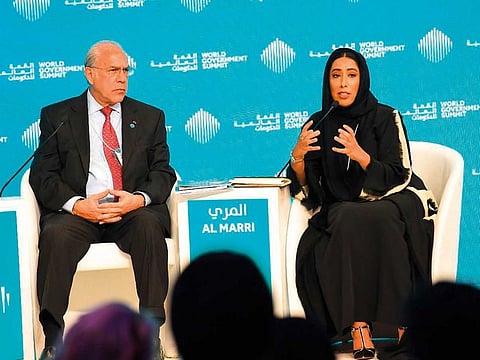 Mona Al Merri and Jose Angel Gurria speaking at a session titled ‘Achieving gender balance: From policies to impact’.