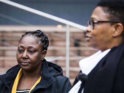 Victoria Bera (L) and Esther Kiobel, two of the widows who's husbands died by executions in 1995, stand outside The Hague courthouse on February 12, 2019.