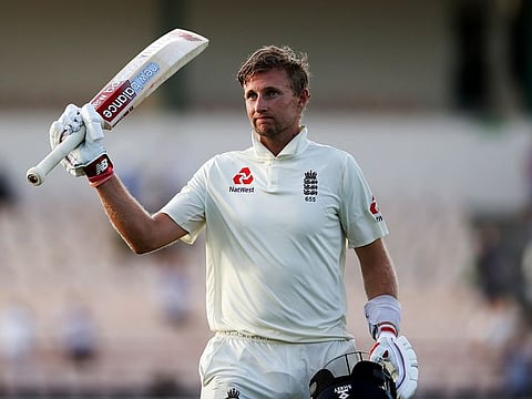 England's captain Joe Root raises his bat as he leaves the field after day three of the third cricket Test match against West Indies at the Daren Sammy Cricket Ground in Gros Islet, St. Lucia, Monday, Feb. 11, 2019.
