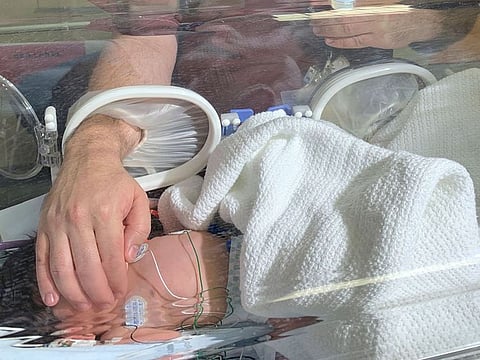 A doctor treats a baby in hospital after she was rescued from a storm water pipe in Durban, South Africa, Monday, Feb. 11, 2019.