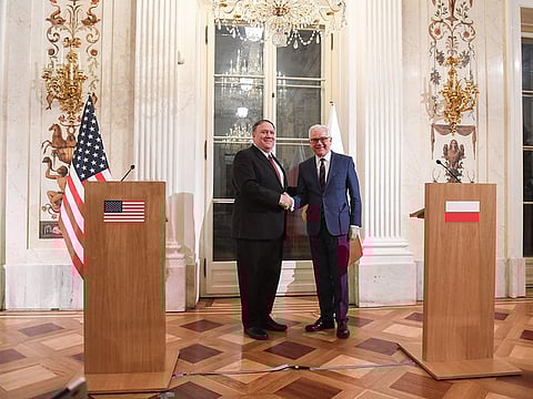 Polish Foreign Minister Jacek Czaputowicz (R) and US Secretary of State Mike Pompeo shake hands during a joint press conference