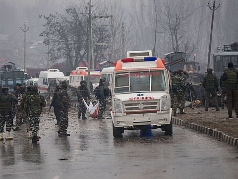 Indian paramilitary soldiers carry the remains of colleagues at the site of an explosion in Pampore, Indian-controlled Kashmir, Thursday, February 14, 2019.