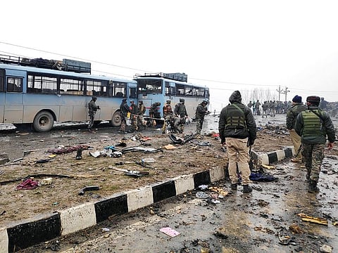 Indian soldiers examine the debris after an explosion in Lethpora in south Kashmir's Pulwama district on Thursday, February 14, 2019.