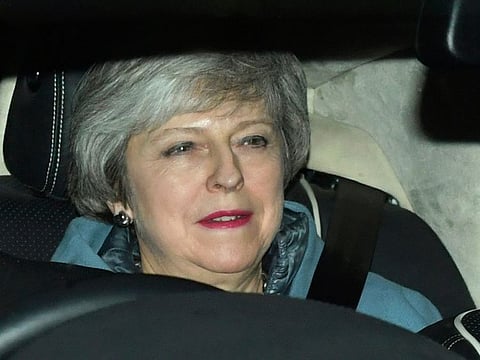 Britain's Prime Minister Theresa May leaves the Houses of Parliament in Westminster following a Brexit vote in the House of Commons, in London, Thursday Feb. 14, 2019.