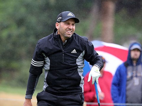 Sergio Garcia, of Spain, stands on the first green in the rain in the Pro-Am round of the Genesis Open golf tournament at Riviera Country Club in the Pacific Palisades area of Los Angeles Wednesday, Feb. 13, 2019.