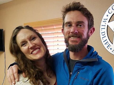 Travis Kauffman and Annie Bierbouer embracing moments before a press conference after surviving a mountain lion attack in Denver, Colorado.