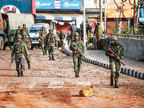 Army personnel patrol a street during a curfew, imposed after clashes between two communities over the protest against the Pulwama terror attack, in Jammu