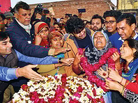 Family members of slain CRPF Jawan Kaushal Kumar Rawat pay their last respects before his funeral procession, in Agra