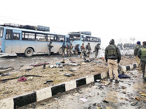 Indian soldiers examine the debris after an explosion in Lethpora in south Kashmir's Pulwama district.