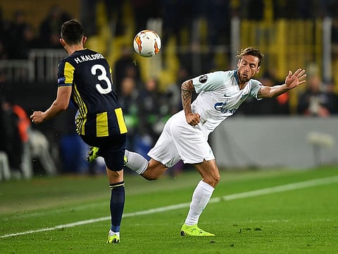 Fenerbahce's Turkish defender Hasan Ali Kaldirim (L) fights for the ball with Zenit St. Petersburg's Italian midfielder Claudio Marchisio during the UEFA Europa League round of 32 first leg football match between Fenerbahce SK and FC Zenit St. Petersburg at the Ulker stadium, in Istanbul, on February 12, 2019