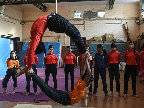 Young visually impaired Indian gymnasts perform a rope version of the Indian ancient sport Mallakhamb at the Shree Samartha Vyayam Mandir in Mumbai. S