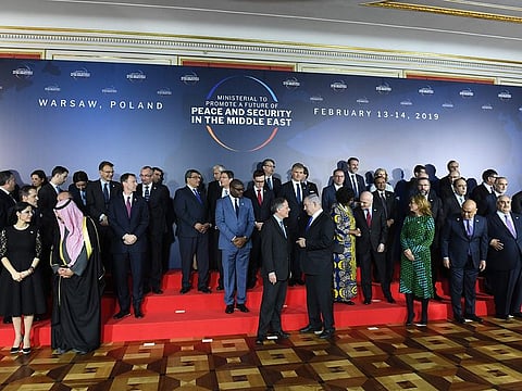 Participants are seen during preparations for a family photo at the conference on Middle East peace and security in Warsaw