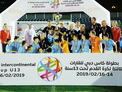 Celta de Vigo team celebrate with the trophy after winning the Under-13 Intercontinental Cup tournament.