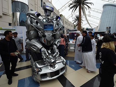 Visitors check out a robot on display during the Think Science Fairs 2019 at Zayed University Academic City.
