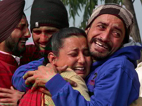 Relatives of Sukhjinder Singh, a Central Reserve Police Force (CRPF) personnel who was killed after a suicide bomber rammed a car into the bus carrying CRPF personnel in south Kashmir on Thursday, cry as his body is taken away for cremation in Gandiwind village, northern state of Punjab, India, on February 16, 2019.