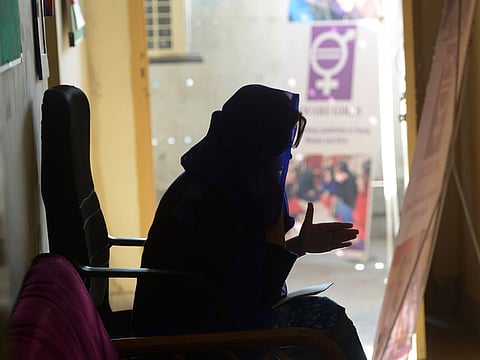 In this picture taken on December 17, 2018, Ayeesha, an employee of the Pakistani NGO Aware Girls, speaks during a call on the hotline "Sahailee" ("friend" in Urdu) dedicated to abortion in Peshawar