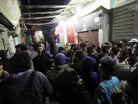 Police officers control the crowd at the scene where policemen were killed when an explosive device carried by a militant they were pursuing exploded in Cairo, Egypt, February 18, 2019.
