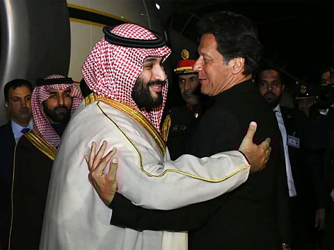 Imran Khan greets Mohammad Bin Salman upon his arrival at the military Nur Khan Air Force base in Islamabad.
