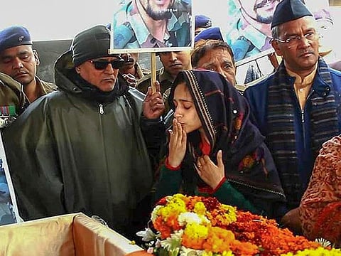 Nitika Kaul, wife of Major Vibhuti Shankar Dhoundiyal, who lost his life in Pulwama attack gestures while paying her last respects to him ahead of his funeral, in Dehradun, Tuesday, Feb 19, 2019.