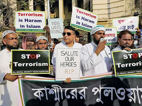 Muslims hold placards during a prayer meeting to pay tribute to Central Reserve Police Force (CRPF) personnel who were killed after a suicide bomber rammed a car into the bus carrying them in south Kashmir last week, outside a mosque in Kolkata, India.