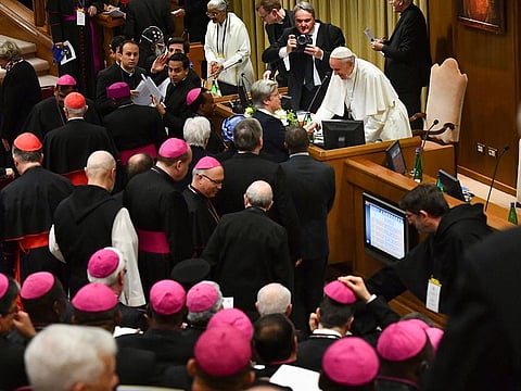 Pope Francis greets bishops as he arrives for a sex abuse prevention summit at the Vatican.