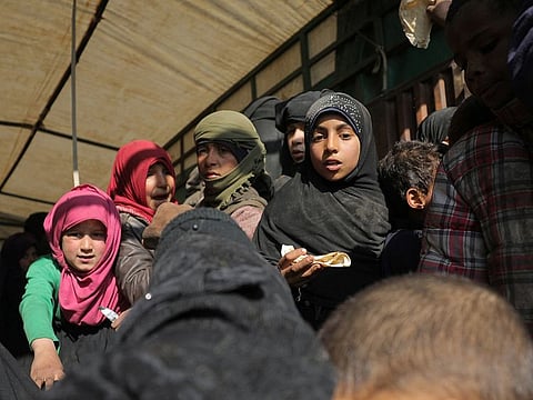 Children stand in the back of a truck near the village of Baghouz, Deir Al Zor province