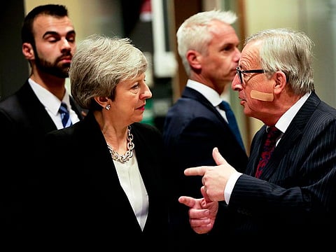 European Commission President Jean-Claude Juncker, right, speaks with British Prime Minister Theresa May prior to a meeting at EU headquarters in Brussels.