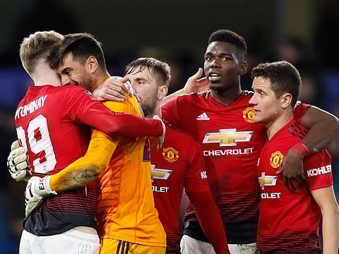 Manchester United players celebrate winning with a 2-0 score at the end of the English FA Cup fifth round soccer match between Chelsea and Manchester United at Stamford Bridge stadium in London, Monday, Feb. 18, 2019.