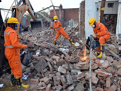 DRF team inspect the area where an explosion caused three houses to collapse, in Bhadohi district of Uttar Pradesh, Saturday, Feb 23, 2019.