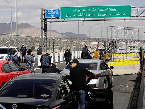 Drivers wait in a queue as a fork-lift truck places a concrete K-rail with concertina wire at Cordova-Americas bridge to enhance security efforts in preparation for increasing number of migrants arriving at the border, as seen from Ciudad Juarez, Mexico February 22, 2019.