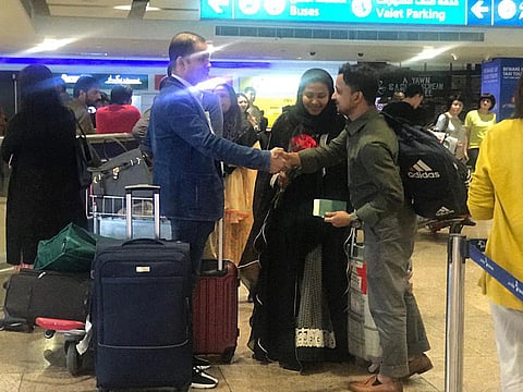 Kabir Ahmed receives his wife and other passngers with a bunch of flowers at Dubai Airport terminal 1 as she arrives from a traumatic hijacked flight to Dubai.