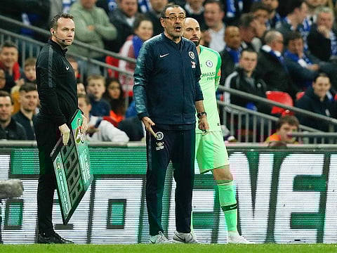 Chelsea's coach Maurizio Sarri (centre) reacts after their goalkeeper Kepa Arrizabalaga remains on the pitch after an attempt to substitute him for goalkeeper Willy Caballero (right) during the English League Cup final football match between Manchester City and Chelsea at Wembley stadium in north London on February 24, 2019.
