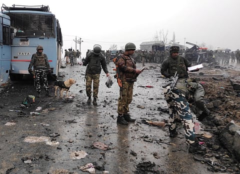 Indian soldiers examine the debris after an explosion in Lethpora in south Kashmir's Pulwama district February 14, 2019.