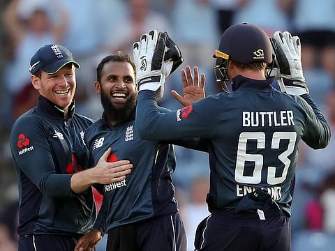 England's spin bowler Adil Rashid celebrates with captain Eoin Morgan and wicket keeper Jos Buttler.