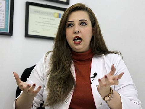 Iraqi family physician Shaymaa Al Kamali speaks at her practice in Baghdad. In Iraq, medicine is a matter of life or death -- not just for patients, but for doctors facing threats by vengeful relatives and forced to flee the country en masse