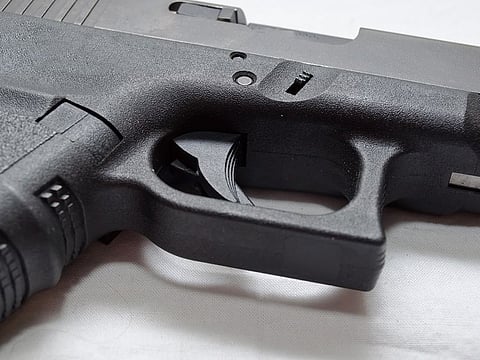 A close up of a black semi automatic pistol. For illustrative purposes only.