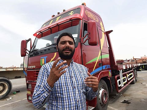 Mohammad Bilal, Heavy driver is seen during an interview in front his vehicle in Mussaffah