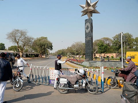 Pakistani police officers block a road to Karachi airport after it was close for civilian operations amid tension along the border with India, in Karachi, Pakistan, Wednesday, Feb. 27, 2019.