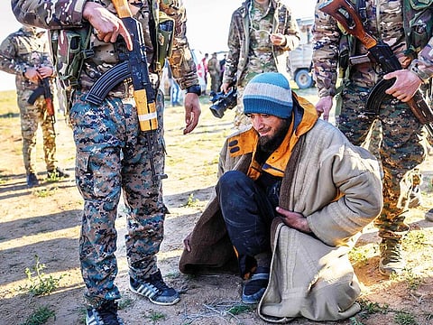 A man from Bosnia, suspected of being a Daesh terrorist, is frisked by members of the Kurdish-led Syrian Democratic Forces in Syria’s northern Deir Ezzor province on Friday.