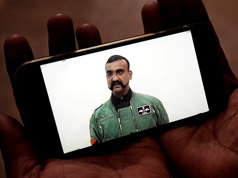 A man watches a statement of Indian Air Force pilot Abhinandan Varthaman on his mobile phone.