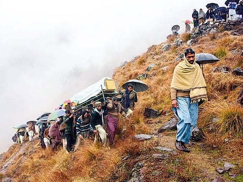 Pakistani Kashmiris during a funeral on the outskirts of Muzaffarabad. The deceased was killed in clashes between Indian and Pakistan forces.