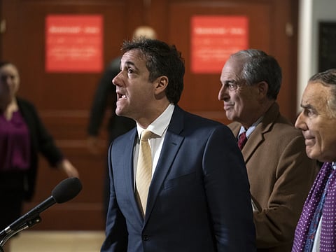 President Donald Trump's former lawyer, Michael Cohen, joined at right by his attorneys Lanny Davis and Michael Monico, leaves a closed-door interview with the House Intelligence Committee at the end of three days of congressional testimony on Capitol Hill in Washington, Thursday, February 28, 2019.