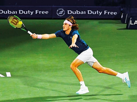 Stefanos Tsitsipas returns the ball to Roger Federe during the final of Dubai Duty Free Tennis Championship.