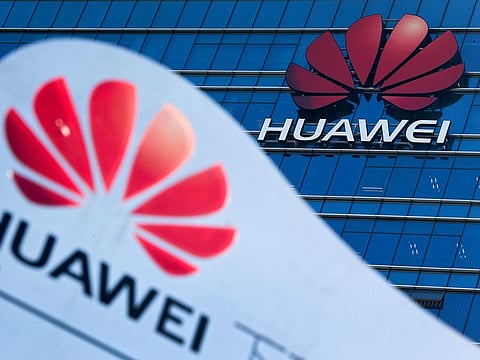 A company signage on display near the Huawei office building at its research and development center in Dongguan, in south China's Guangdong province.
