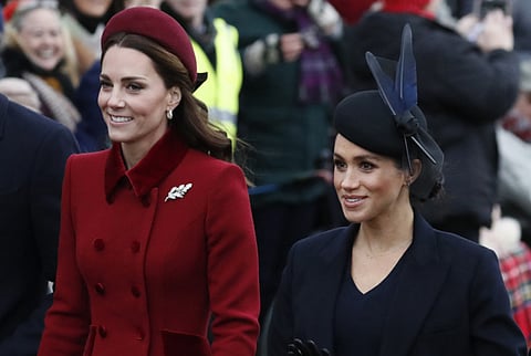 Britain's Kate, Duchess of Cambridge, left, and Meghan, Duchess of Sussex.