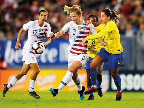United States' Samantha Mewis drives past Brazil's Erika during the first half of a SheBelieves Cup soccer match