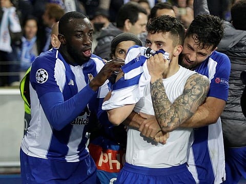 FC Porto's Alex Telles celebrates scoring their third goal with team mates.