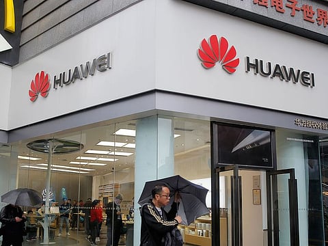 A man walks past a Huawei retail shop in Shenzhen, China's Guangdong province.