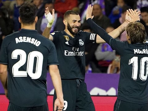 Real Madrid's Croatian midfielder Luka Modric (R) celebrates his goal.