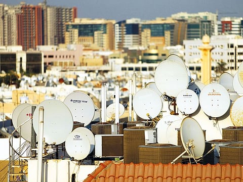 Satellite dishes are seen for the rooftop of the buildings